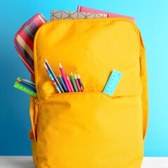 Backpack,With,Different,Colorful,Stationery,On,Table.,Banner,Design